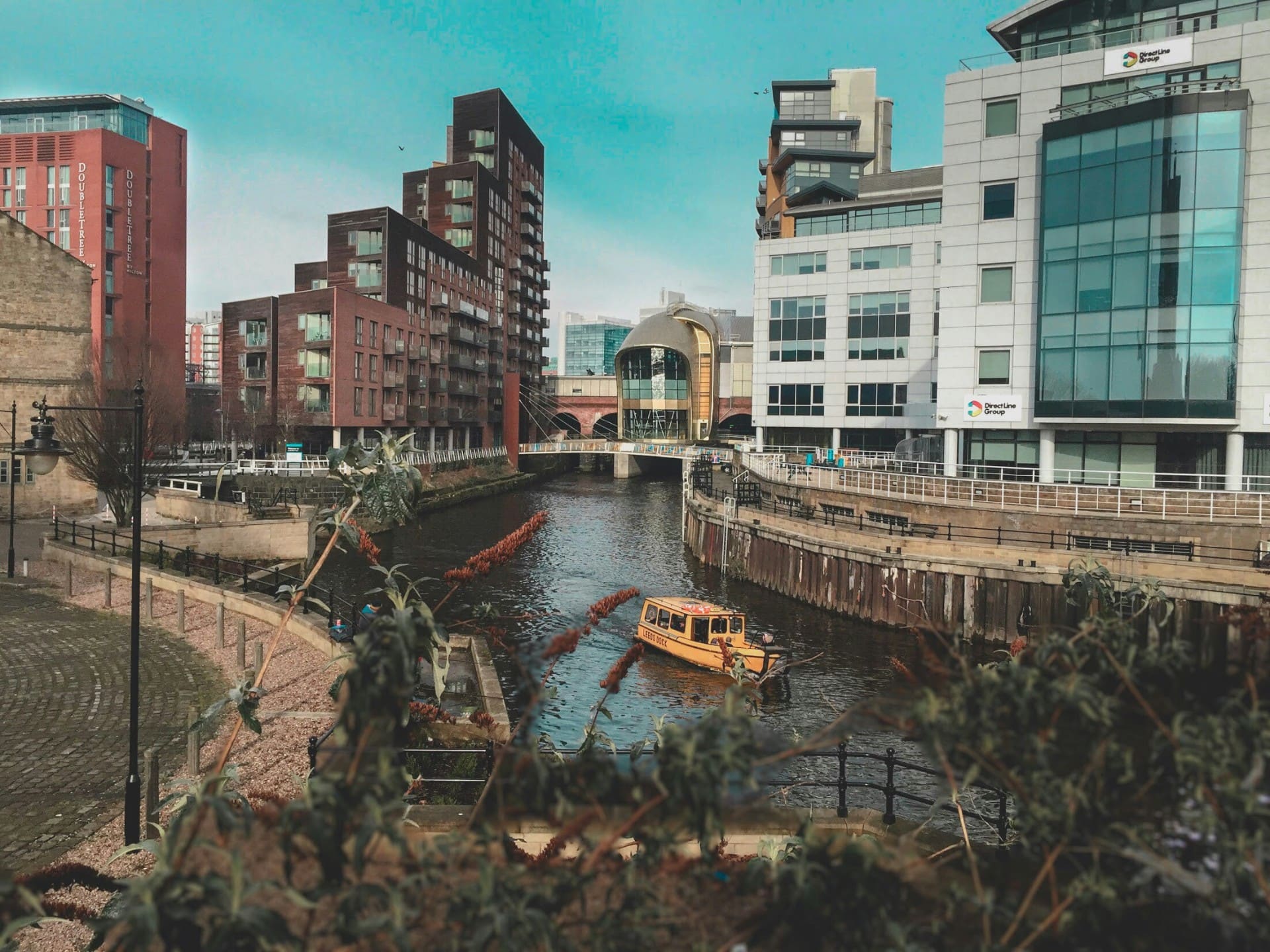 Leeds Dock waterfront with water taxi and modern buildings — social media agency in Leeds